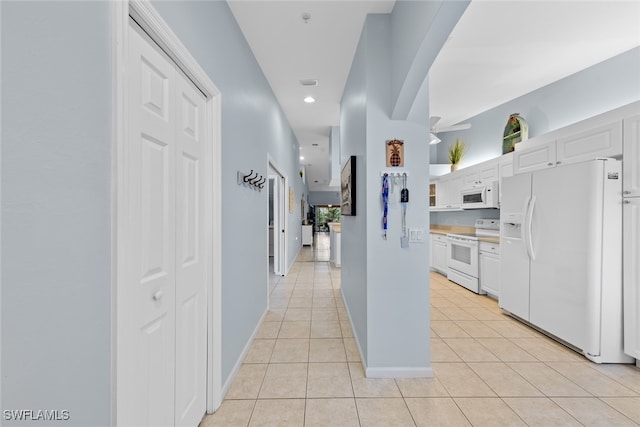 hallway featuring light tile patterned flooring