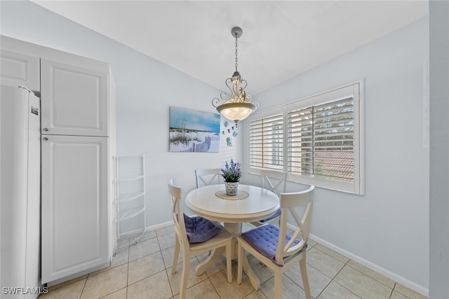 dining room featuring lofted ceiling and light tile patterned floors