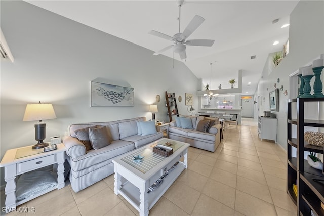 living room featuring ceiling fan with notable chandelier, light tile patterned floors, and high vaulted ceiling