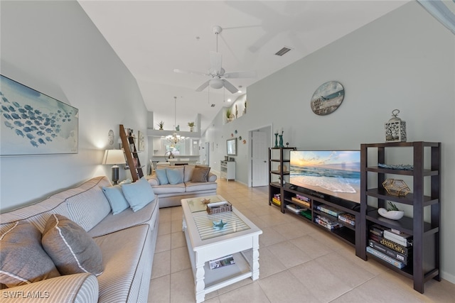 living room featuring ceiling fan with notable chandelier, light tile patterned flooring, and high vaulted ceiling