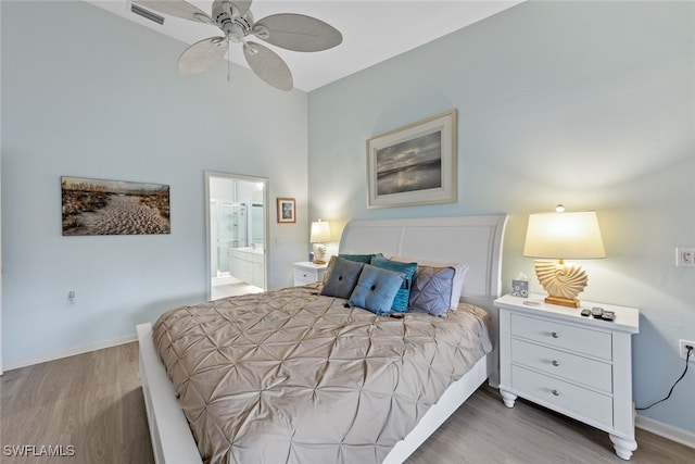 bedroom featuring ceiling fan, hardwood / wood-style floors, and ensuite bathroom