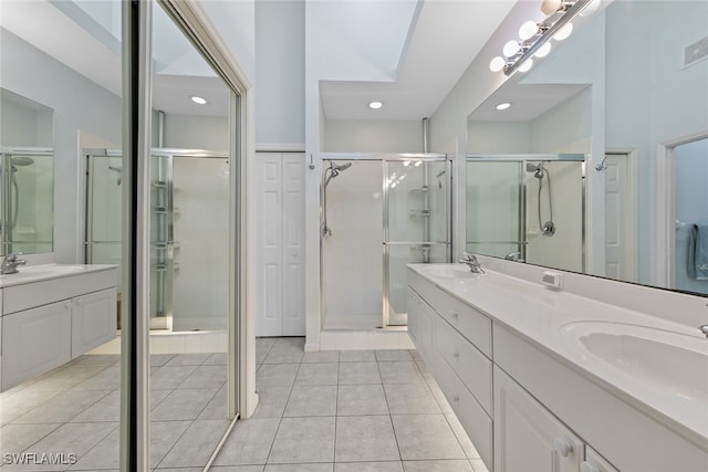 bathroom featuring tile patterned flooring, vanity, and a shower with shower door