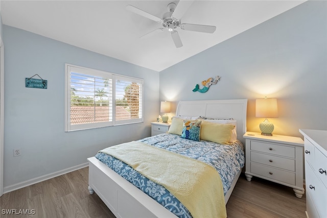 bedroom with dark hardwood / wood-style flooring and ceiling fan