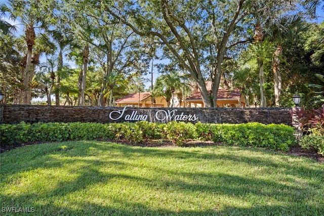 community sign featuring a lawn