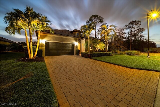 view of front facade with a garage and a lawn