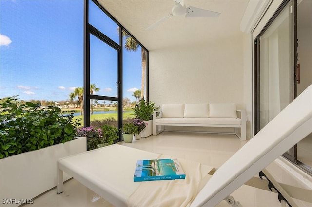 sunroom featuring ceiling fan