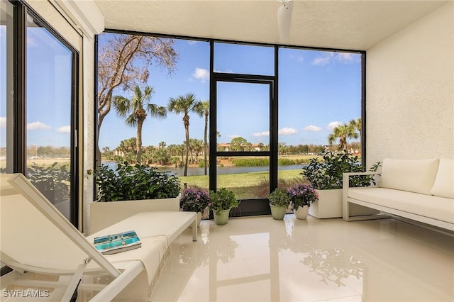 sunroom / solarium with a water view