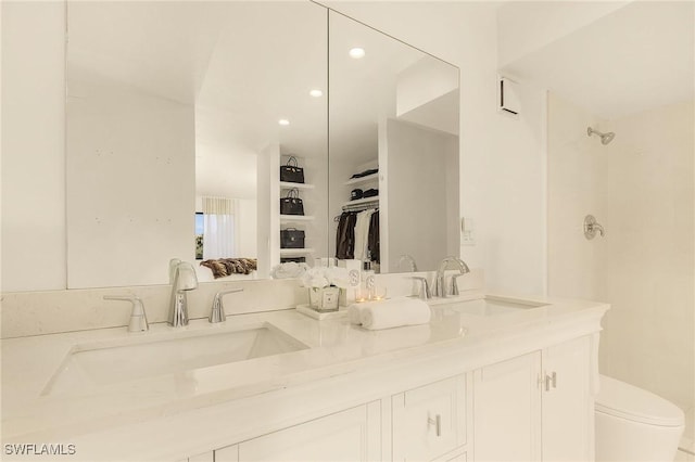 full bath featuring double vanity, a shower, and a sink