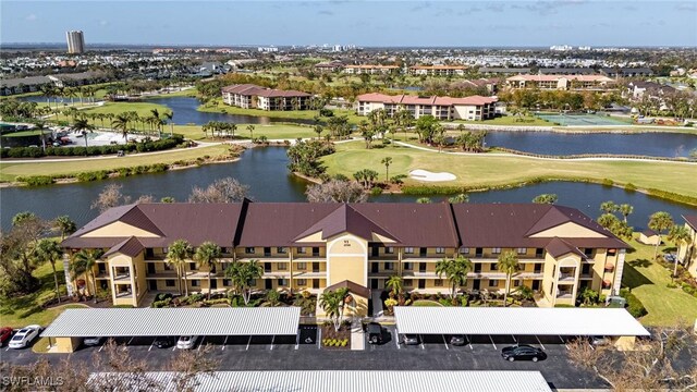 birds eye view of property featuring golf course view, a water view, and a residential view