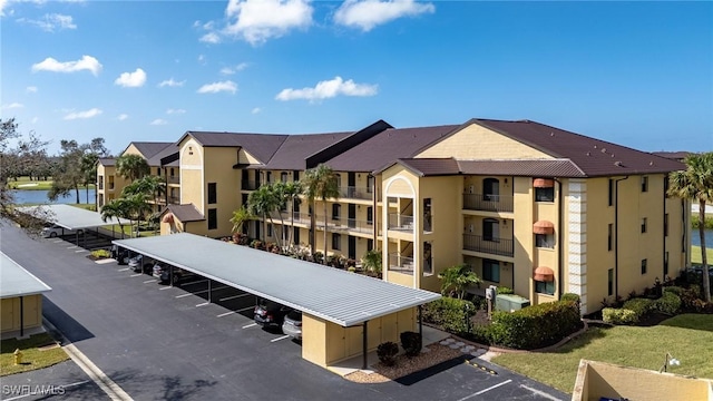 view of building exterior with a residential view and uncovered parking
