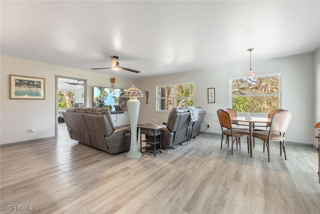 living room featuring ceiling fan and light wood-type flooring