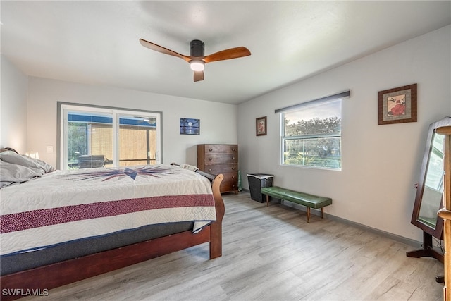 bedroom with light hardwood / wood-style floors and ceiling fan