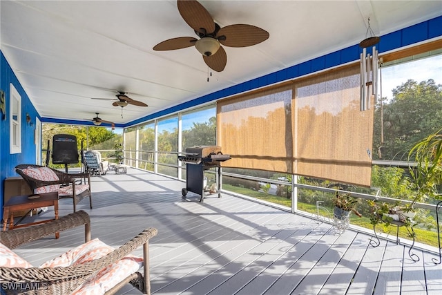 sunroom featuring ceiling fan