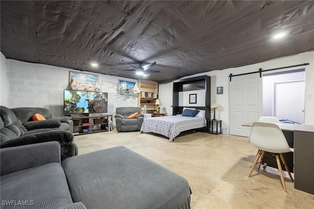 bedroom featuring concrete flooring and a barn door