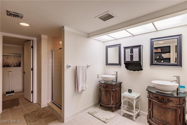 bathroom with tile patterned floors, vanity, an enclosed shower, and crown molding