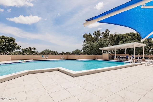 view of swimming pool with a patio