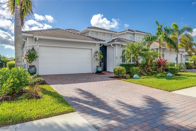 view of front of home featuring a garage and a front lawn