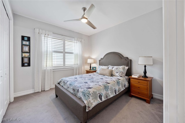 bedroom with light colored carpet, a closet, and ceiling fan