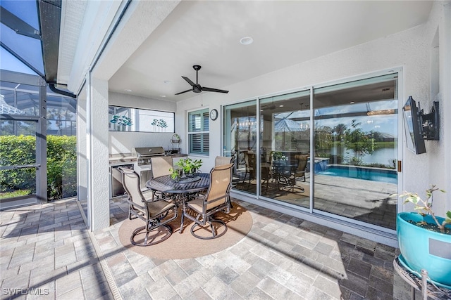 view of patio with ceiling fan and a lanai