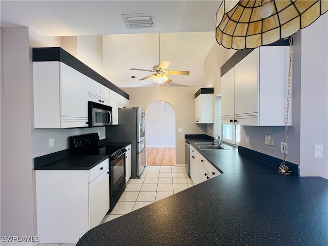 kitchen with light tile patterned flooring, appliances with stainless steel finishes, sink, white cabinets, and ceiling fan