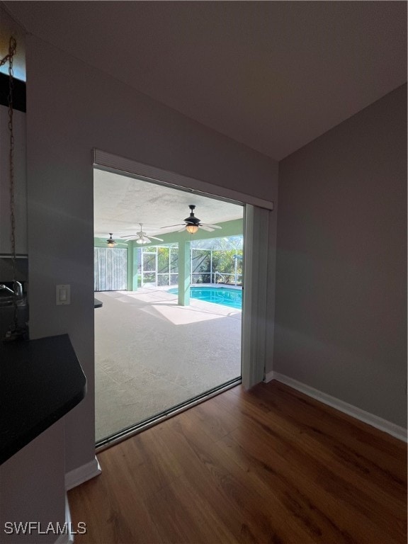 unfurnished living room with hardwood / wood-style flooring and ceiling fan