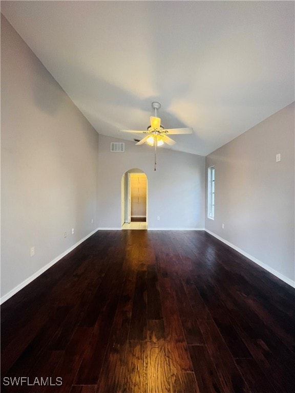 unfurnished living room with ceiling fan, dark hardwood / wood-style floors, and lofted ceiling