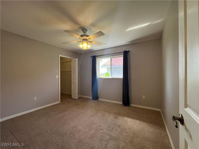 unfurnished room with ceiling fan and carpet floors