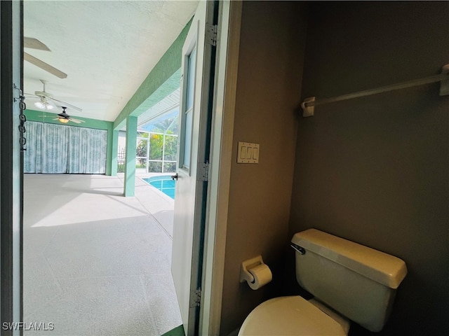 bathroom featuring toilet and ceiling fan