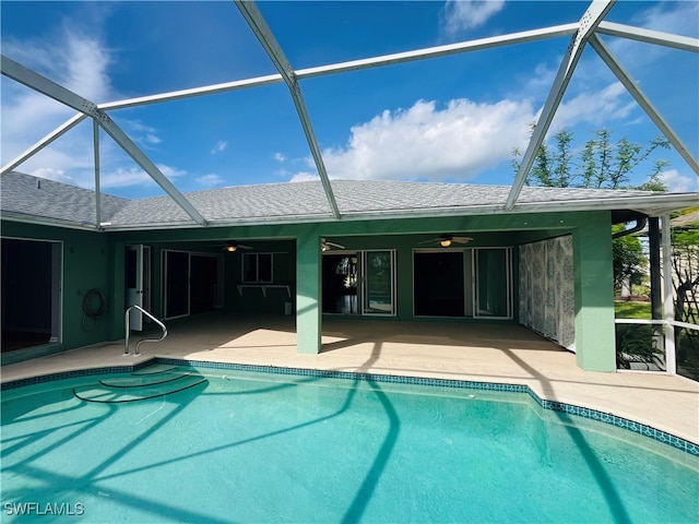 view of pool with ceiling fan, a patio, and a lanai