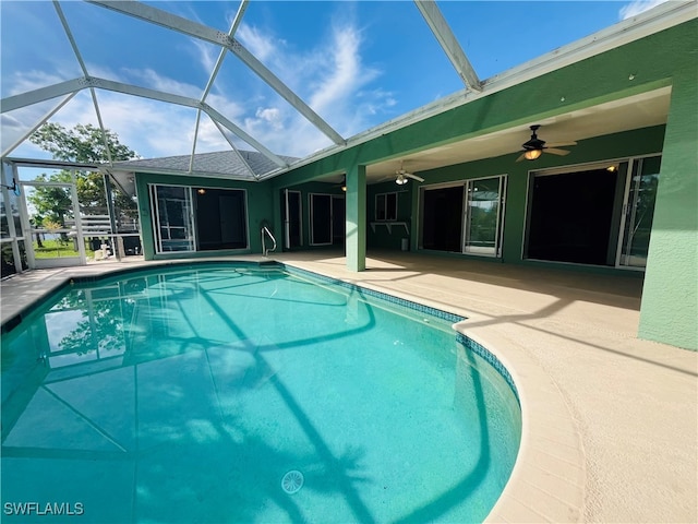 view of swimming pool with a patio area, a lanai, and ceiling fan