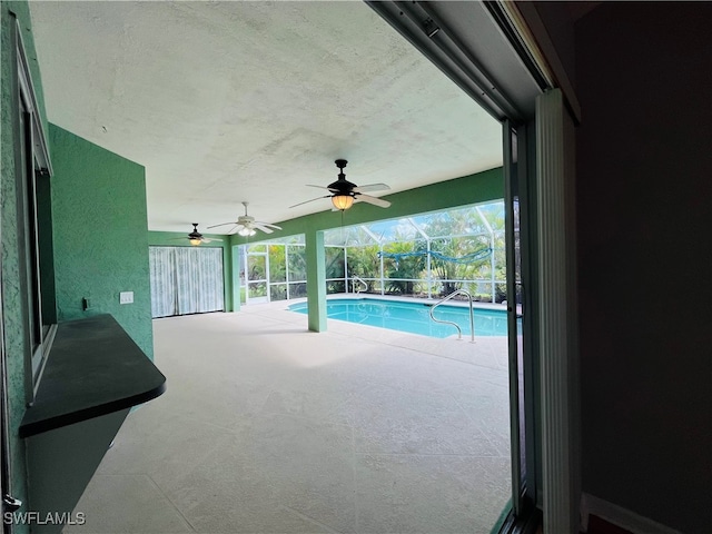 view of swimming pool featuring ceiling fan