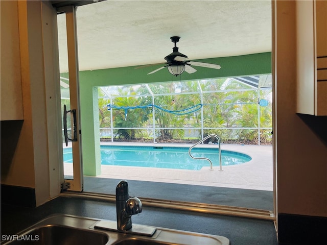 view of swimming pool with sink and ceiling fan