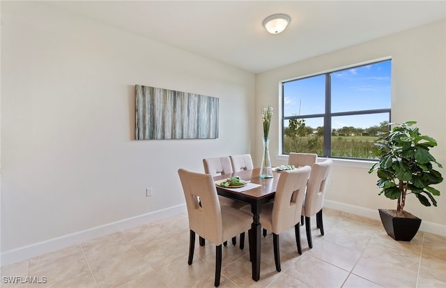 dining space featuring light tile patterned flooring