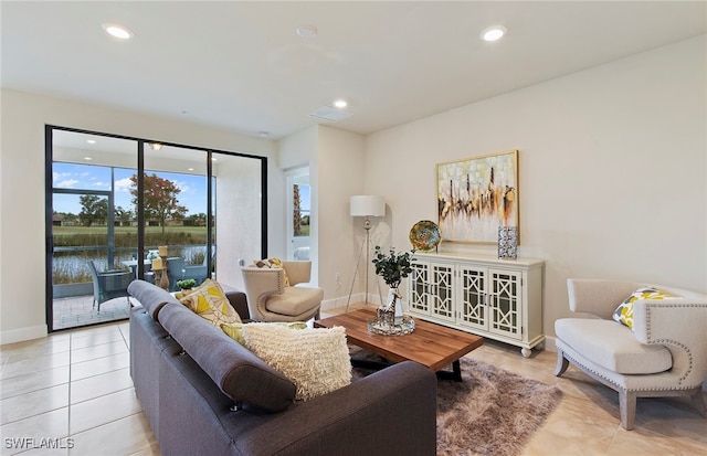 living room with light tile patterned floors and a water view