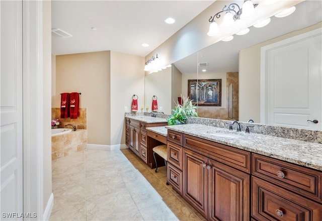 bathroom featuring vanity and a relaxing tiled tub