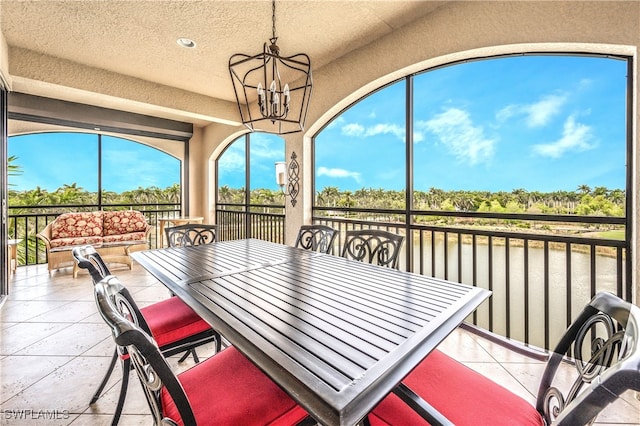 sunroom featuring a notable chandelier