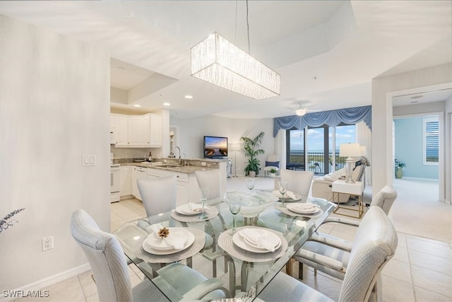 dining space featuring ceiling fan, light tile patterned flooring, and sink