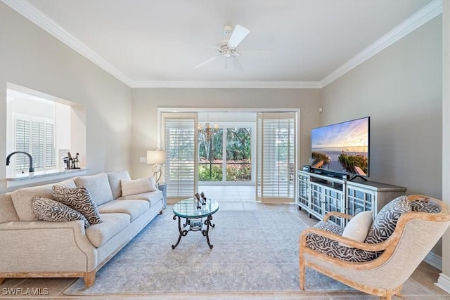 tiled living room with ceiling fan with notable chandelier and ornamental molding