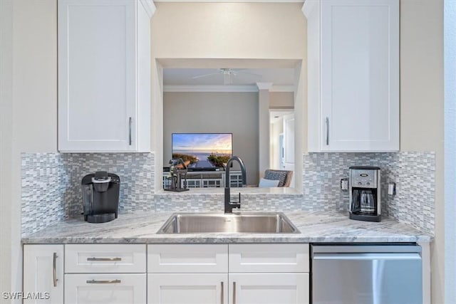 kitchen featuring crown molding, sink, stainless steel dishwasher, decorative backsplash, and white cabinetry