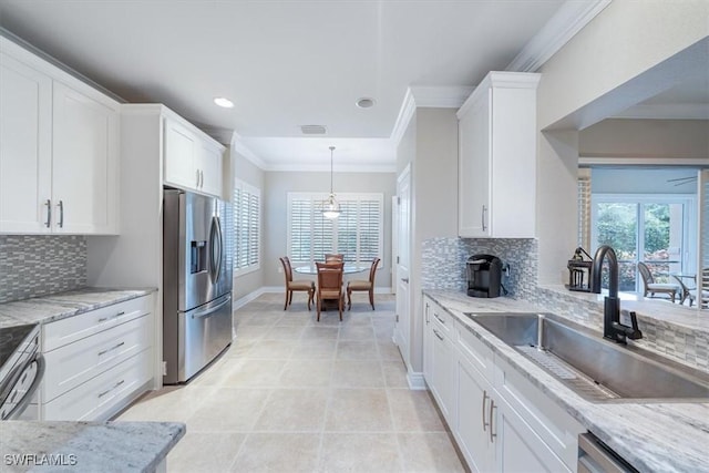 kitchen featuring appliances with stainless steel finishes, backsplash, white cabinetry, and sink