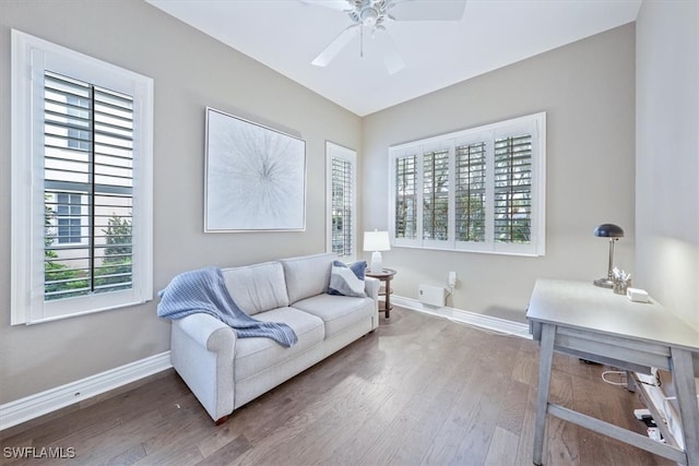 living room with dark hardwood / wood-style floors and ceiling fan