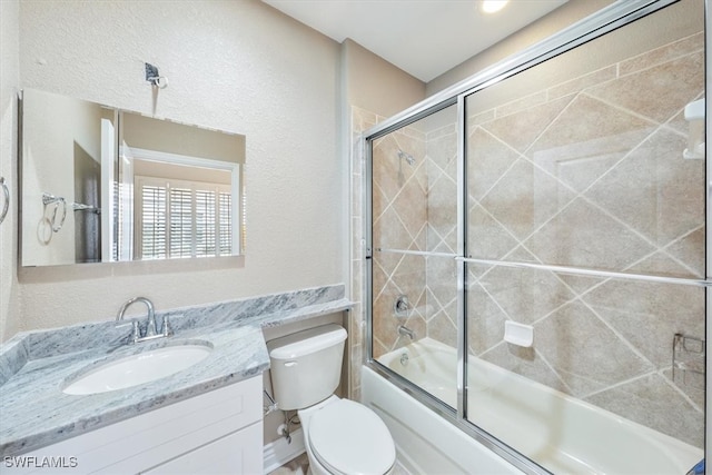 full bathroom featuring vanity, toilet, and enclosed tub / shower combo