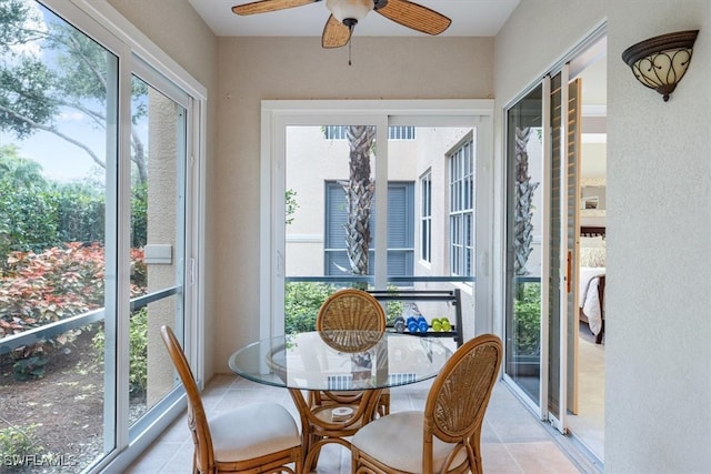 sunroom / solarium featuring ceiling fan