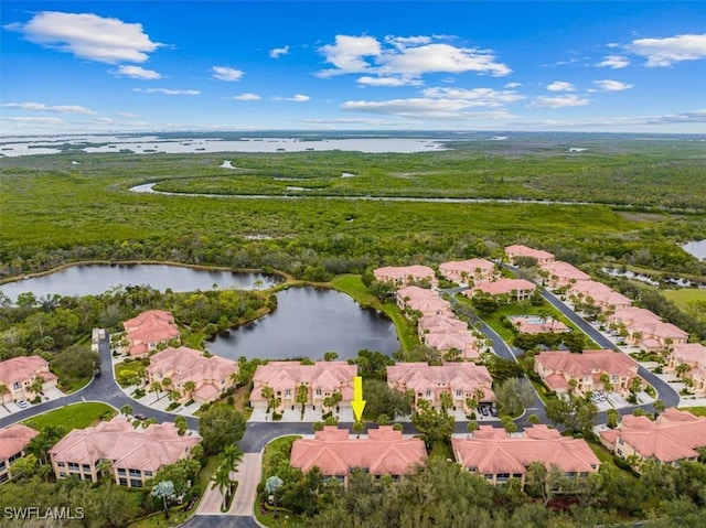 birds eye view of property with a water view