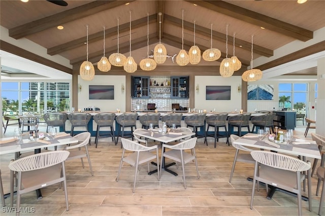 dining area featuring beam ceiling, a healthy amount of sunlight, and wood ceiling