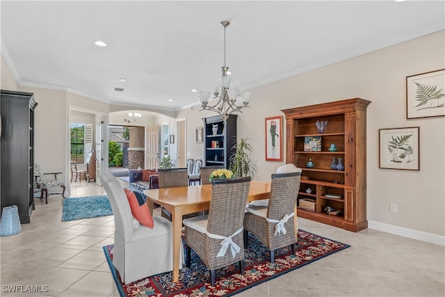 tiled dining room with an inviting chandelier and ornamental molding