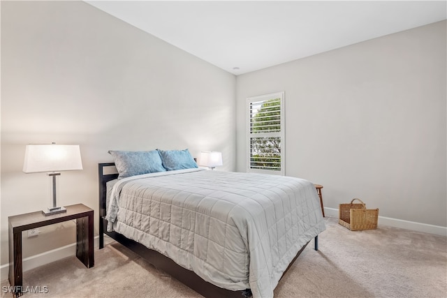 carpeted bedroom with vaulted ceiling