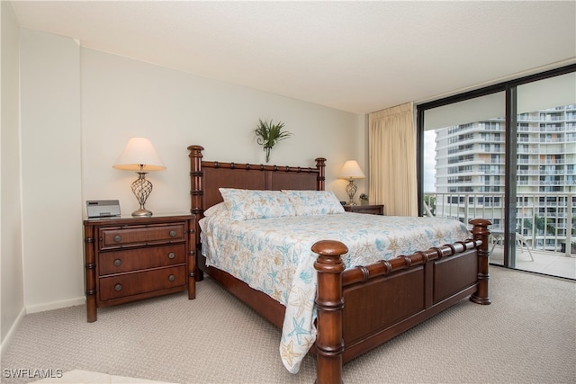 carpeted bedroom with access to exterior and expansive windows