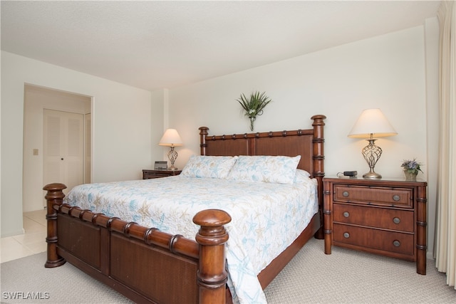 bedroom featuring light carpet and a closet