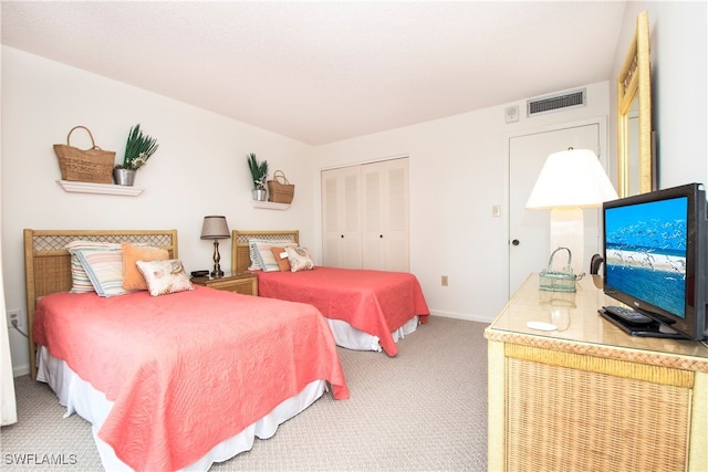 carpeted bedroom with a closet